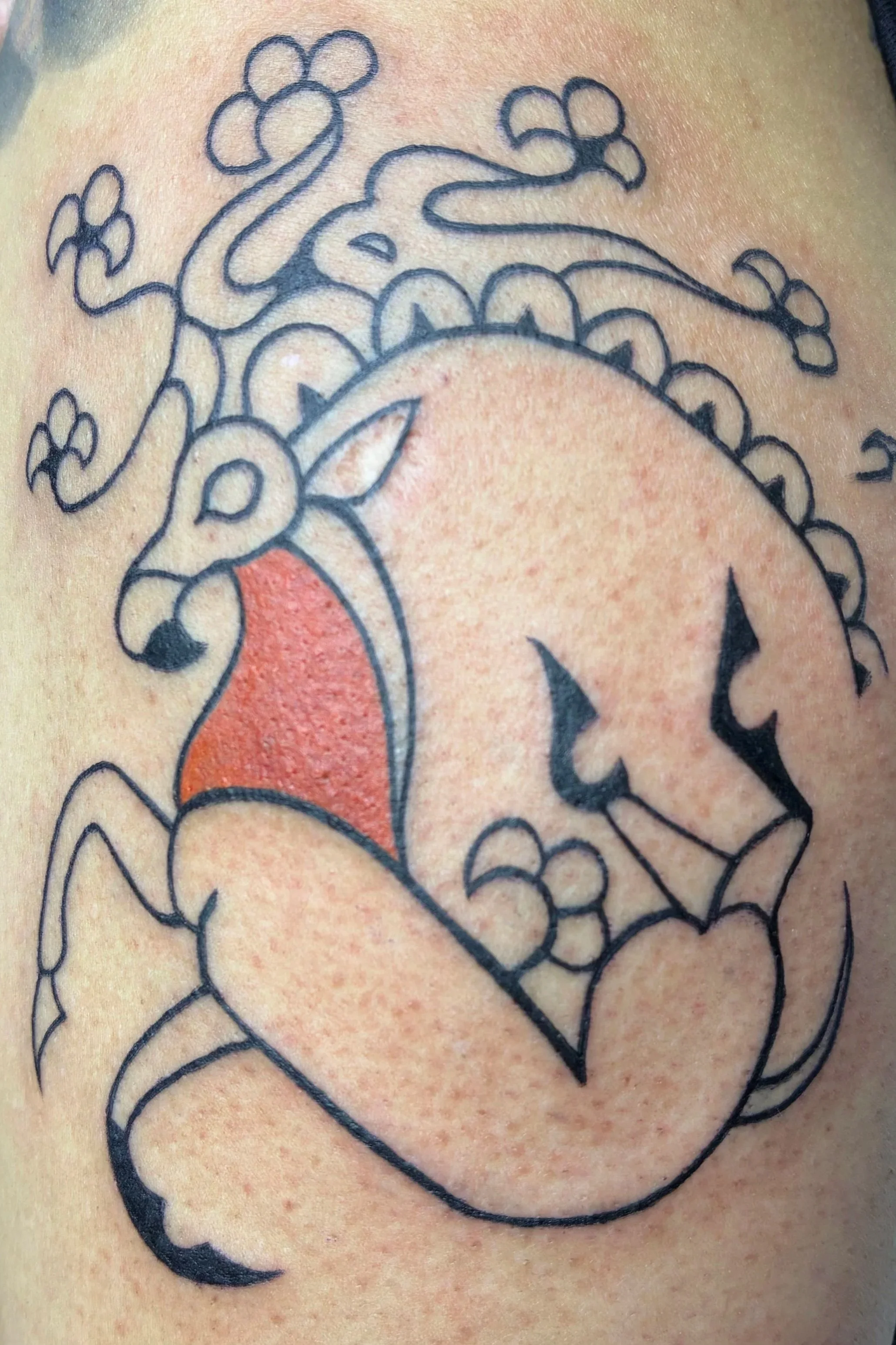 Fineline tattoo of a deer-like creature with floral horns and red accents, ancient shaman illustration