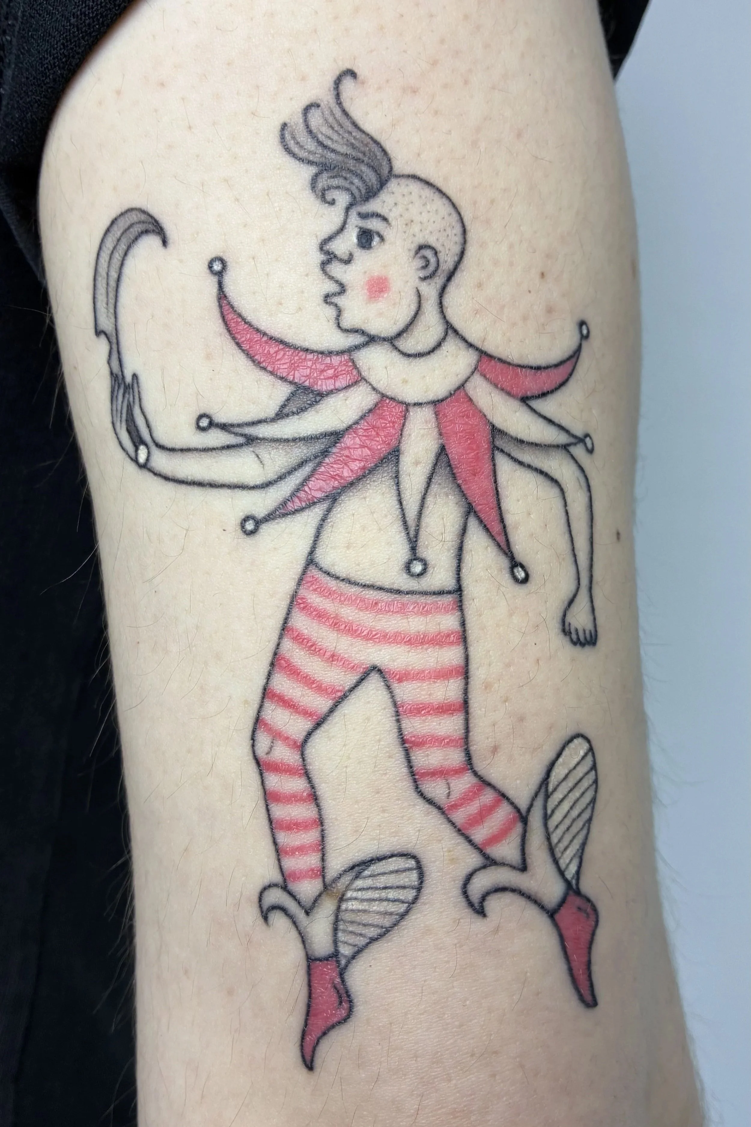 Fineline tattoo of a jester figure in striped tights juggling, medieval court illustration style