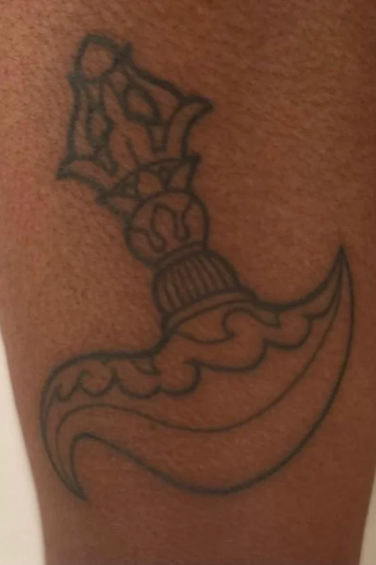 Fineline outline tattoo of an ornate decorative buddhist ritual knife