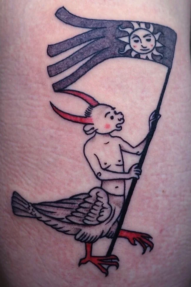 Color tattoo of a horned figure holding a sun banner while riding a bird, medieval heraldic illustration style