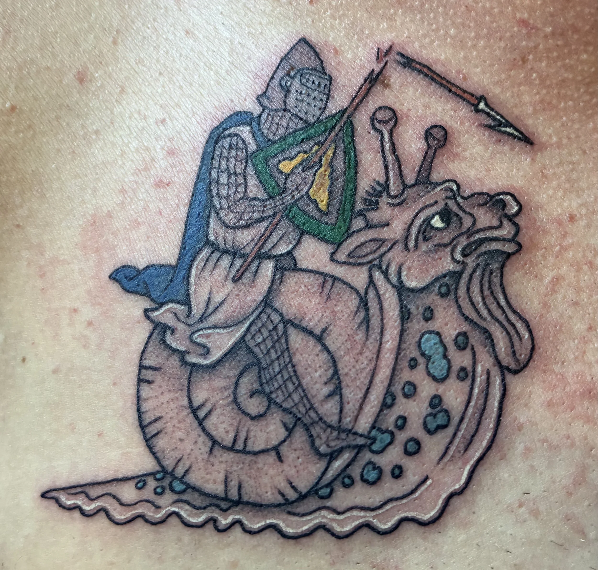 Color tattoo of a knight in armor riding a snail with a spear, medieval manuscript marginalia style