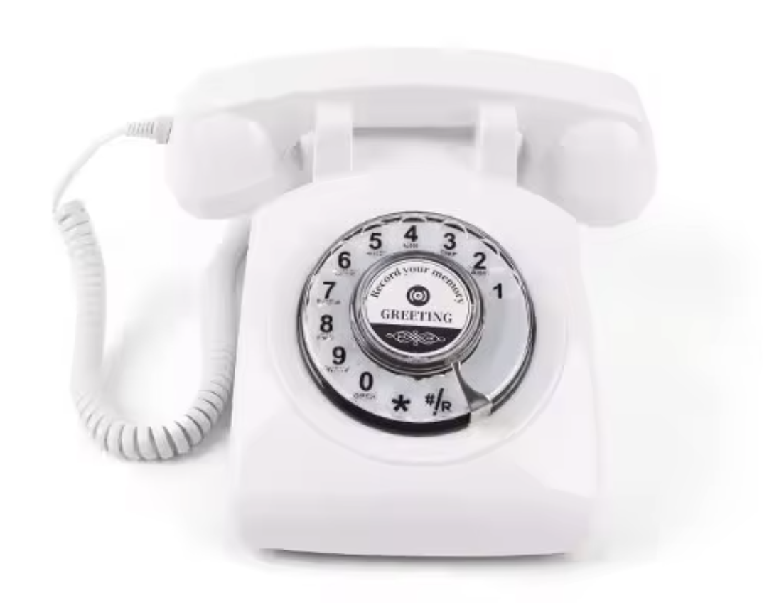 White rotary telephone with a circular dial and a coiled cord