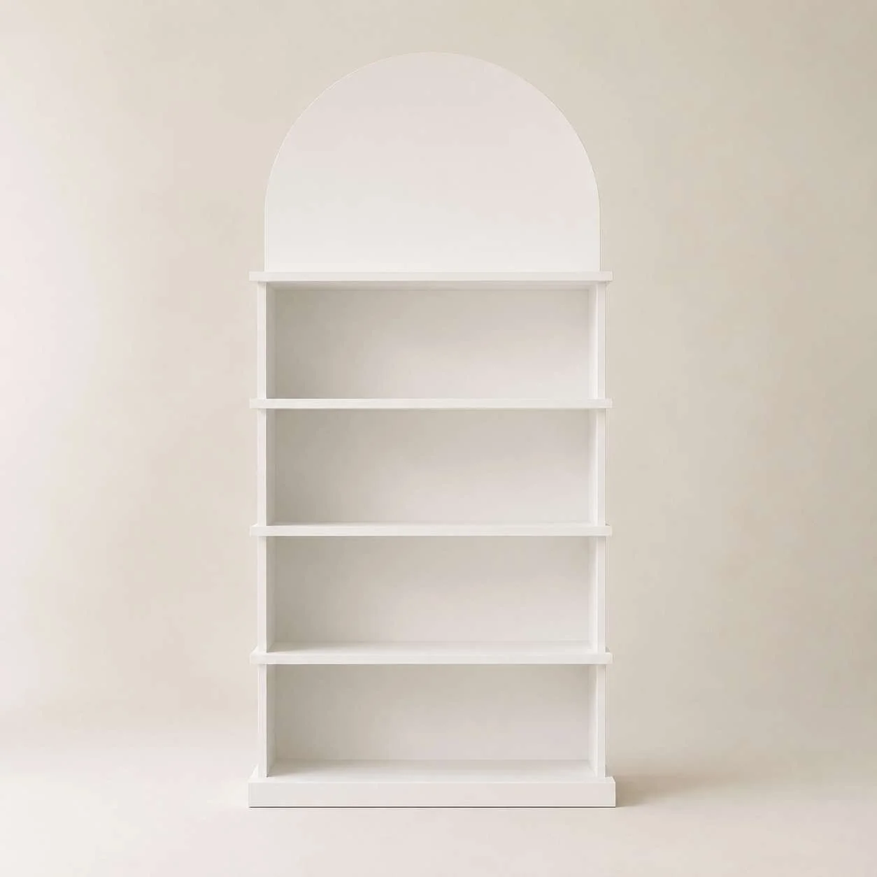 White empty bookshelf with five shelves against a plain light-colored wall.