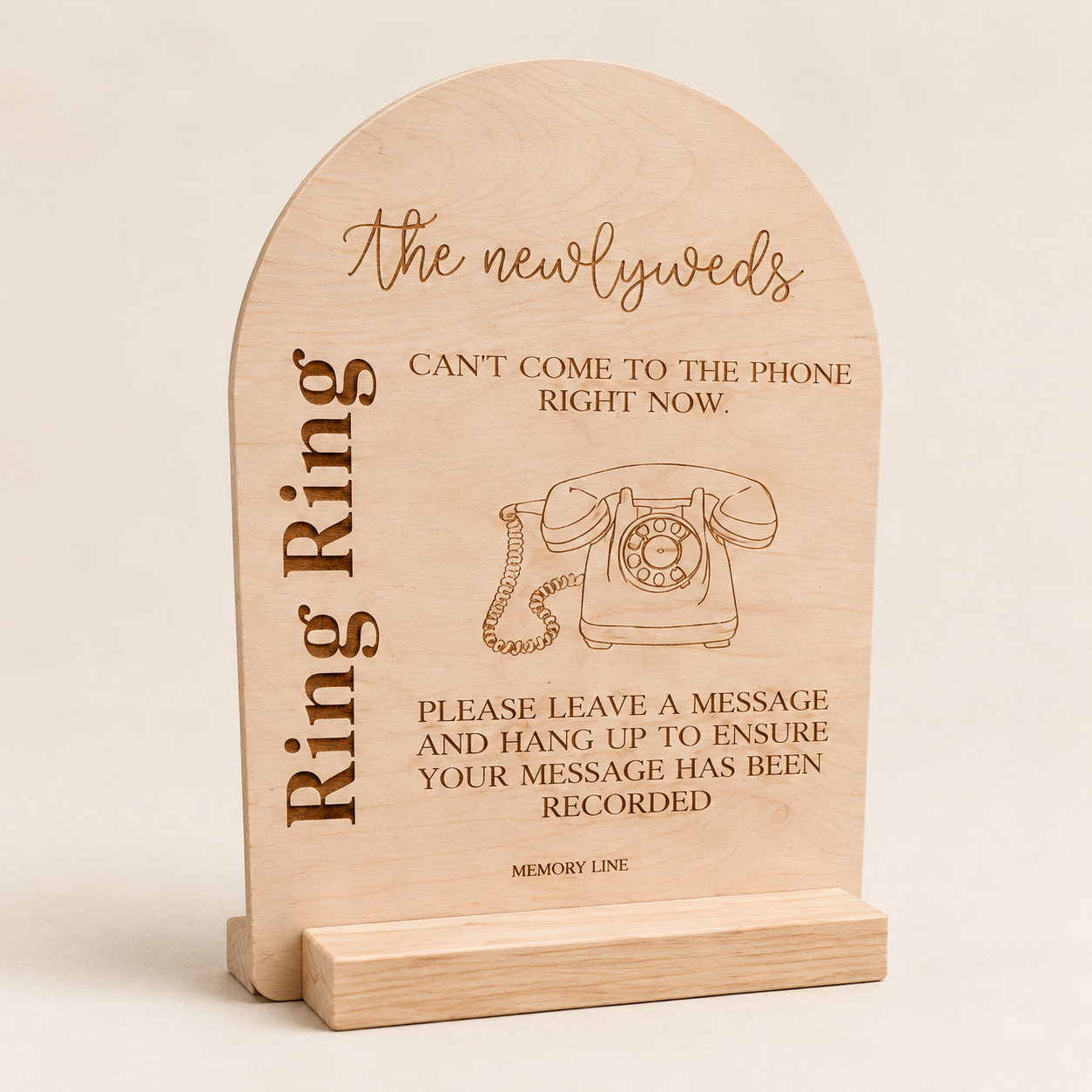 Wooden message board with rotary phone illustration and text for newlyweds, requesting visitors to leave a message and hang up.