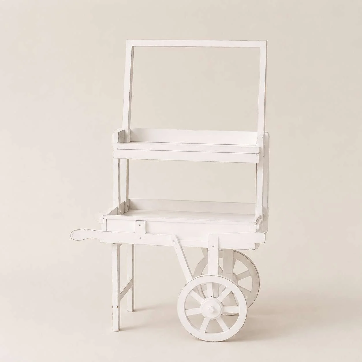 White wooden cart with large rear wheels and a small handle, placed against a plain light background.