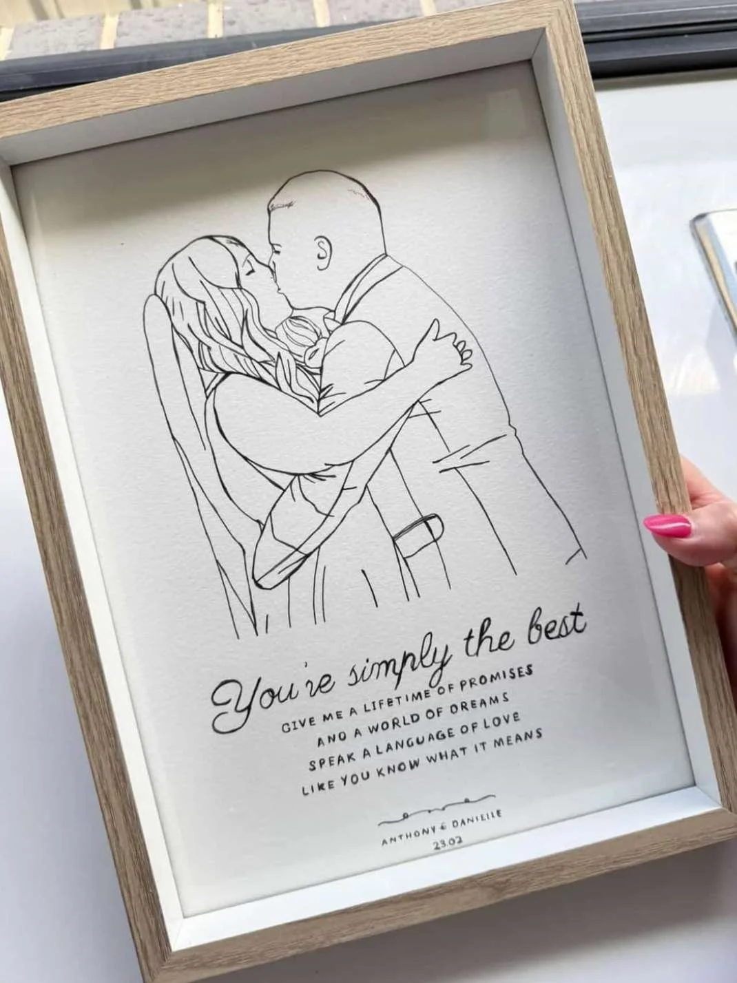 Line art illustration of a couple embracing and kissing, framed with a motivational quote below.
