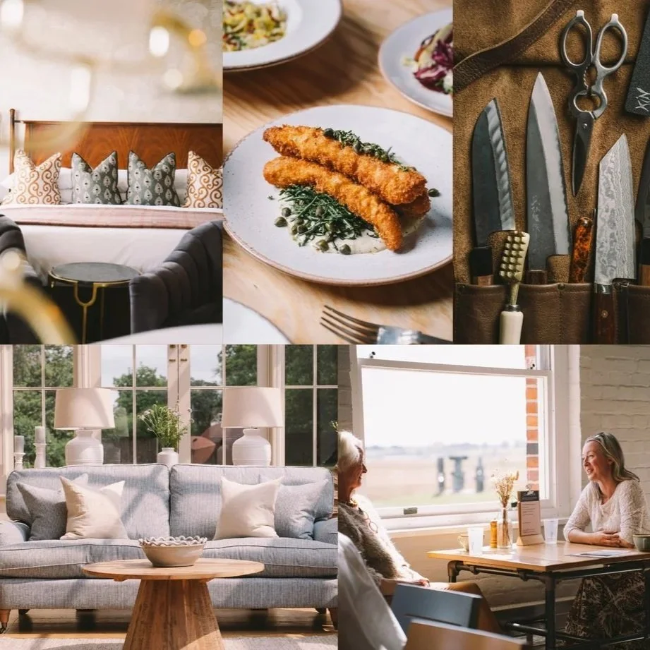 Living room with a gray sofa, white lamps, and natural sunlight; plate of breaded fish fillets with greens on a table; kitchen knives and scissors in a brown knife holder; cozy couch with pillows in front of large windows; two women sitting at a table near a window, smiling and talking.