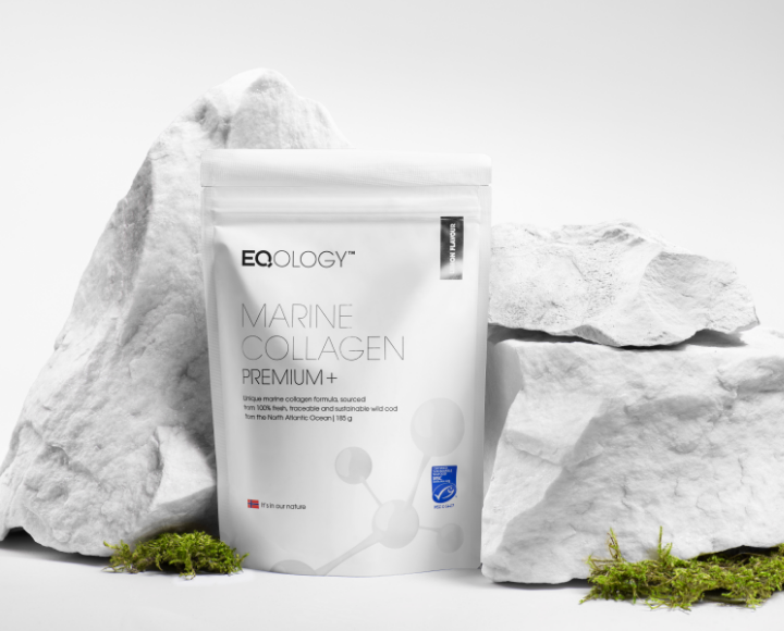 Zwarte en blauwe verpakking voor marine collageen supplement van EQOLOGY, geplaatst tussen witte rotsen en groene moss.