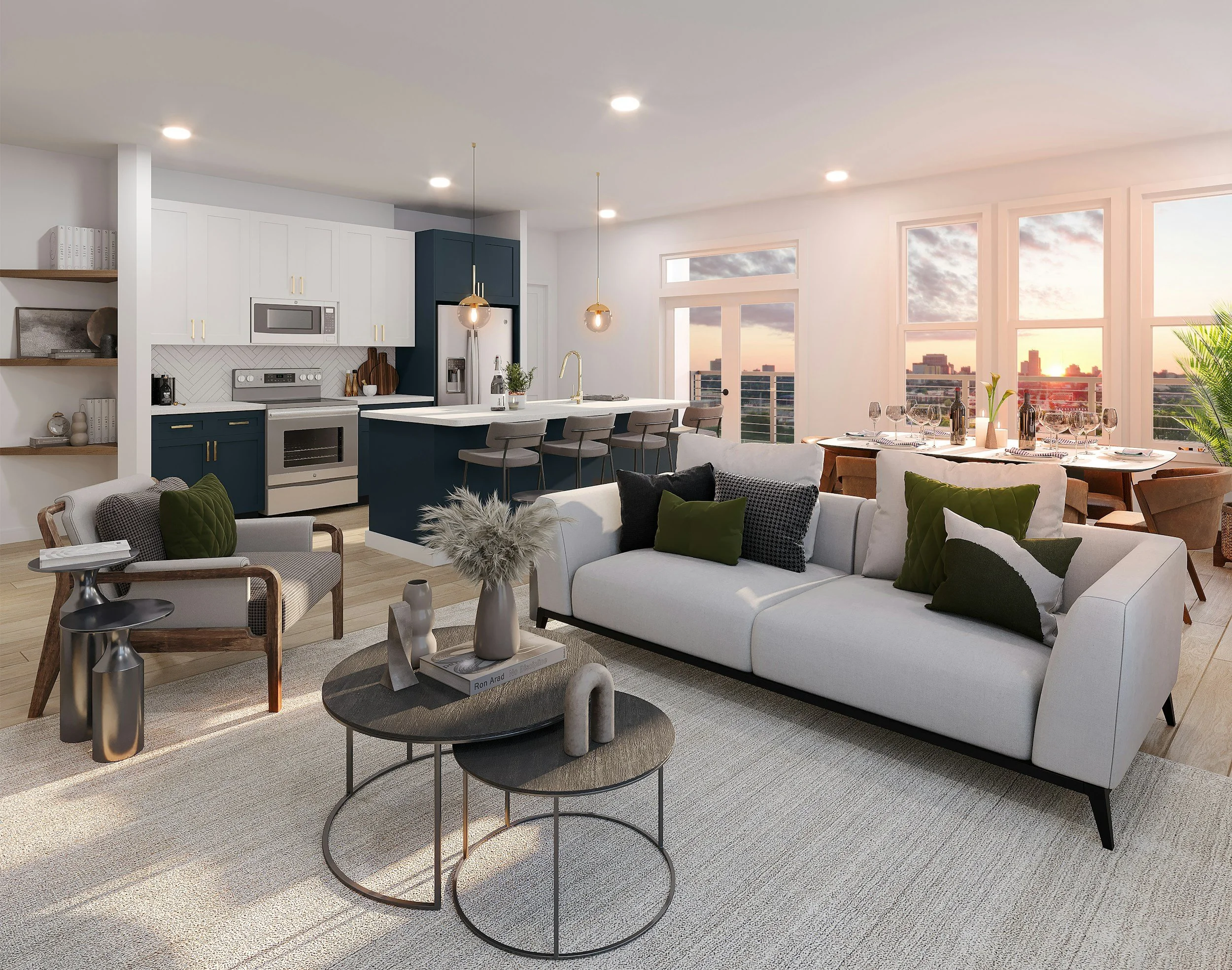 Modern living room with white sofa, black pillows, round coffee tables, and a dining area near large windows revealing a cityscape during sunset.