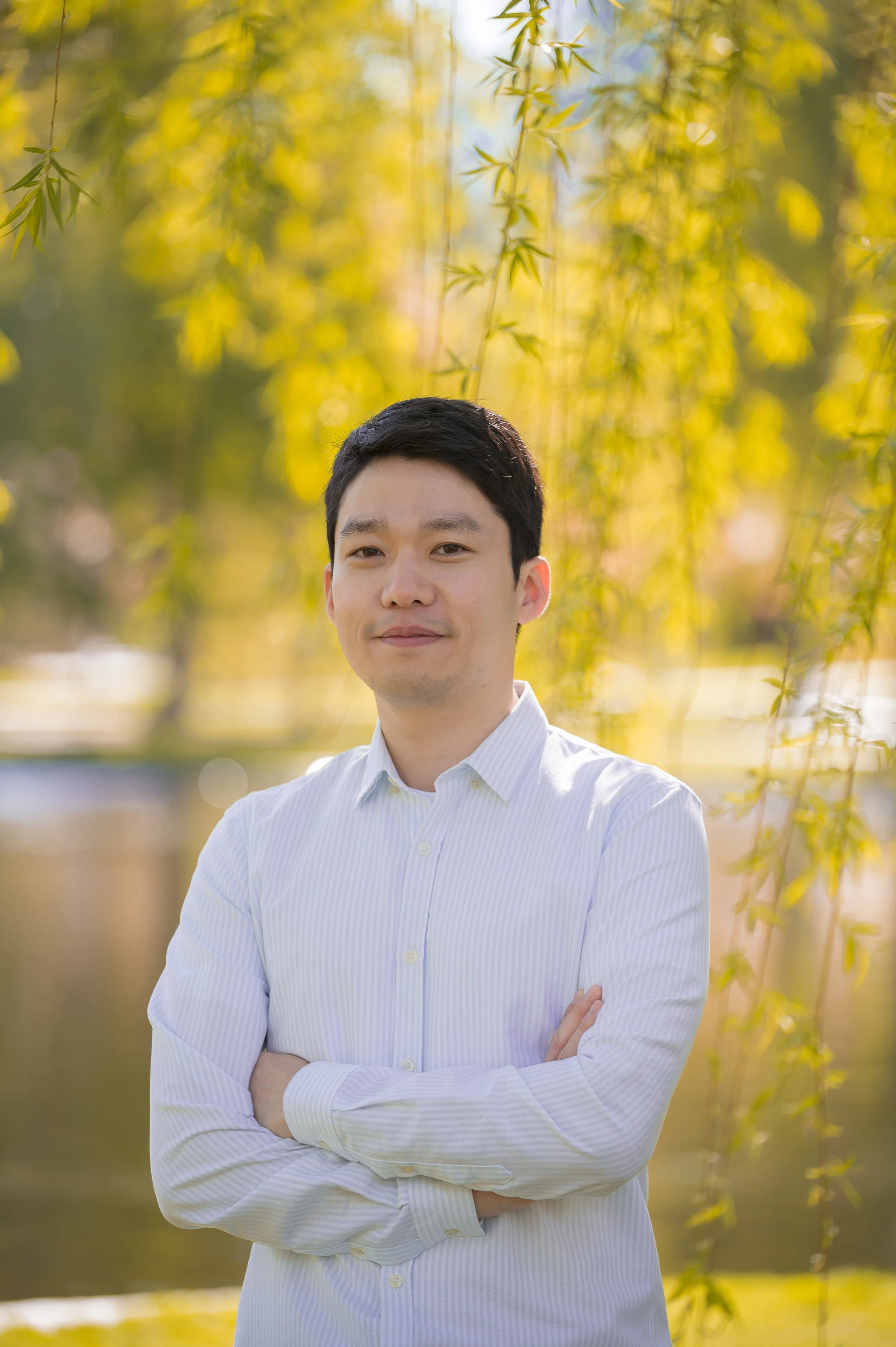 Photograph of Dr Nahm with a bohek background of a nature scene