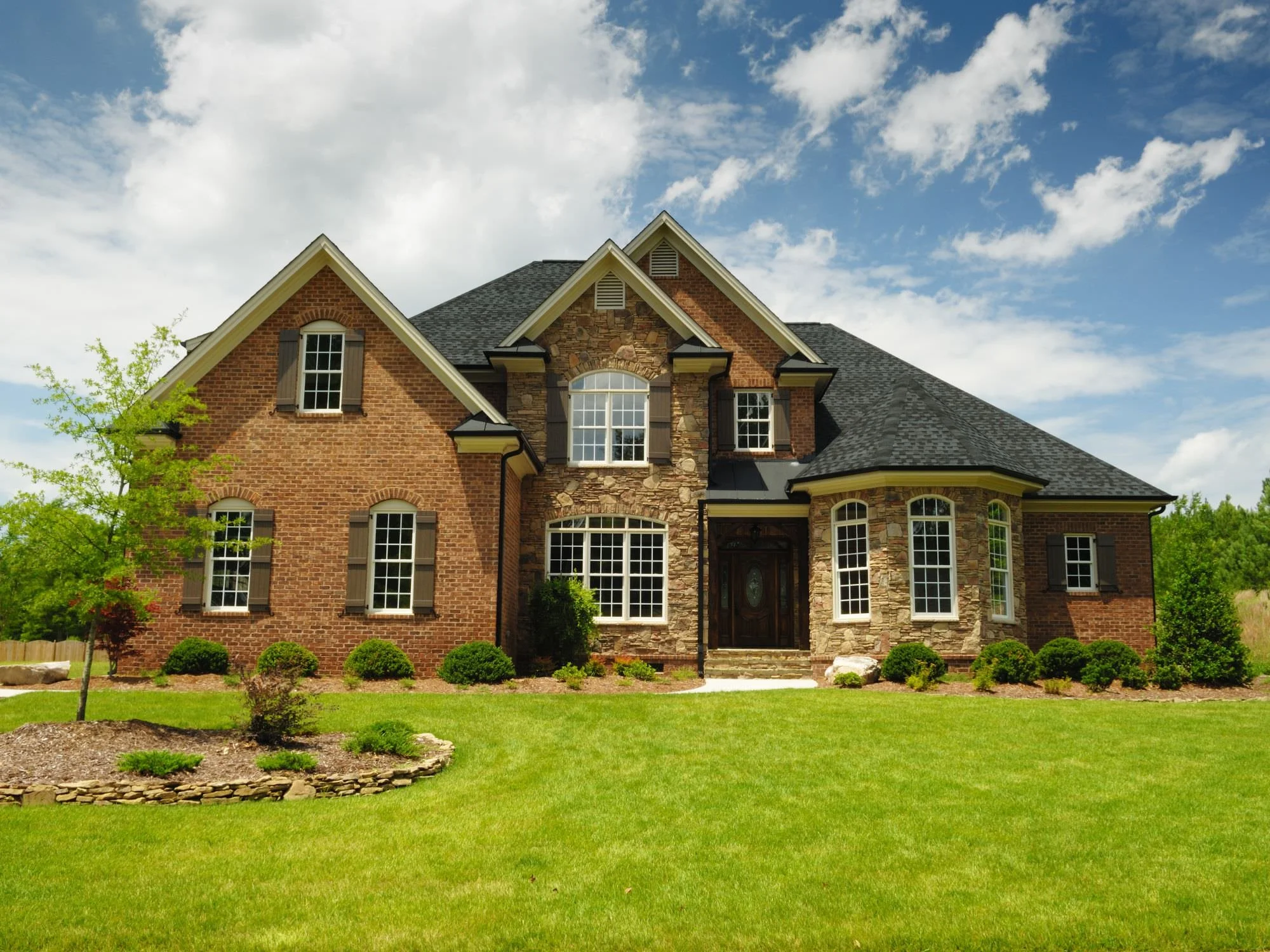 large home with manicured lawn