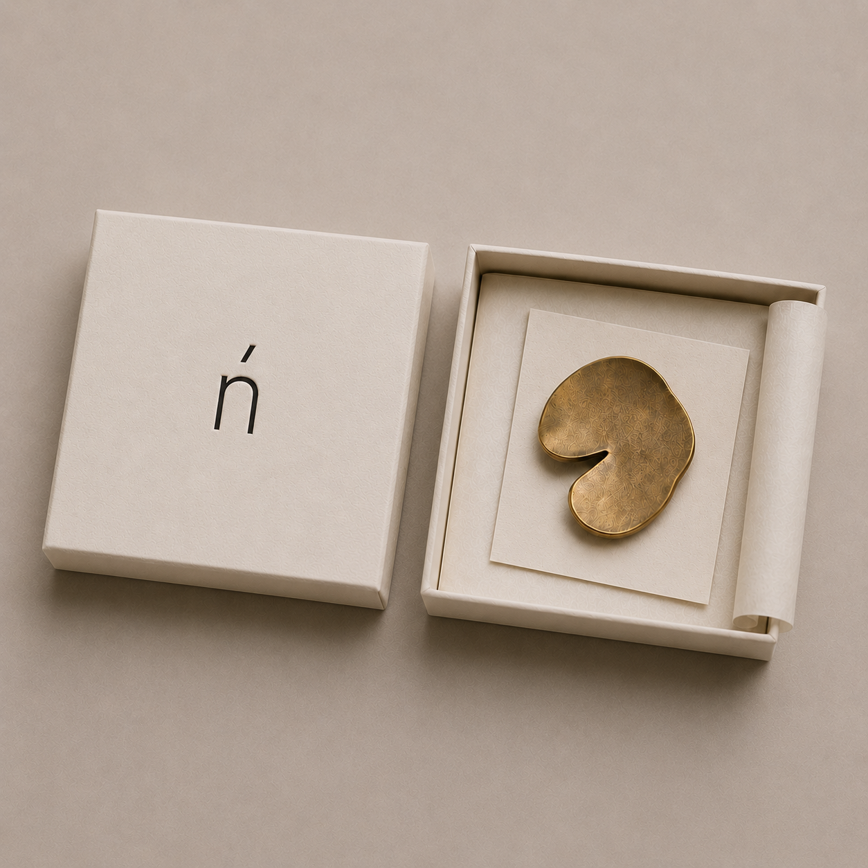 Nenúfar's signature matte brass brooch, presented in a handcrafted keepsake box.