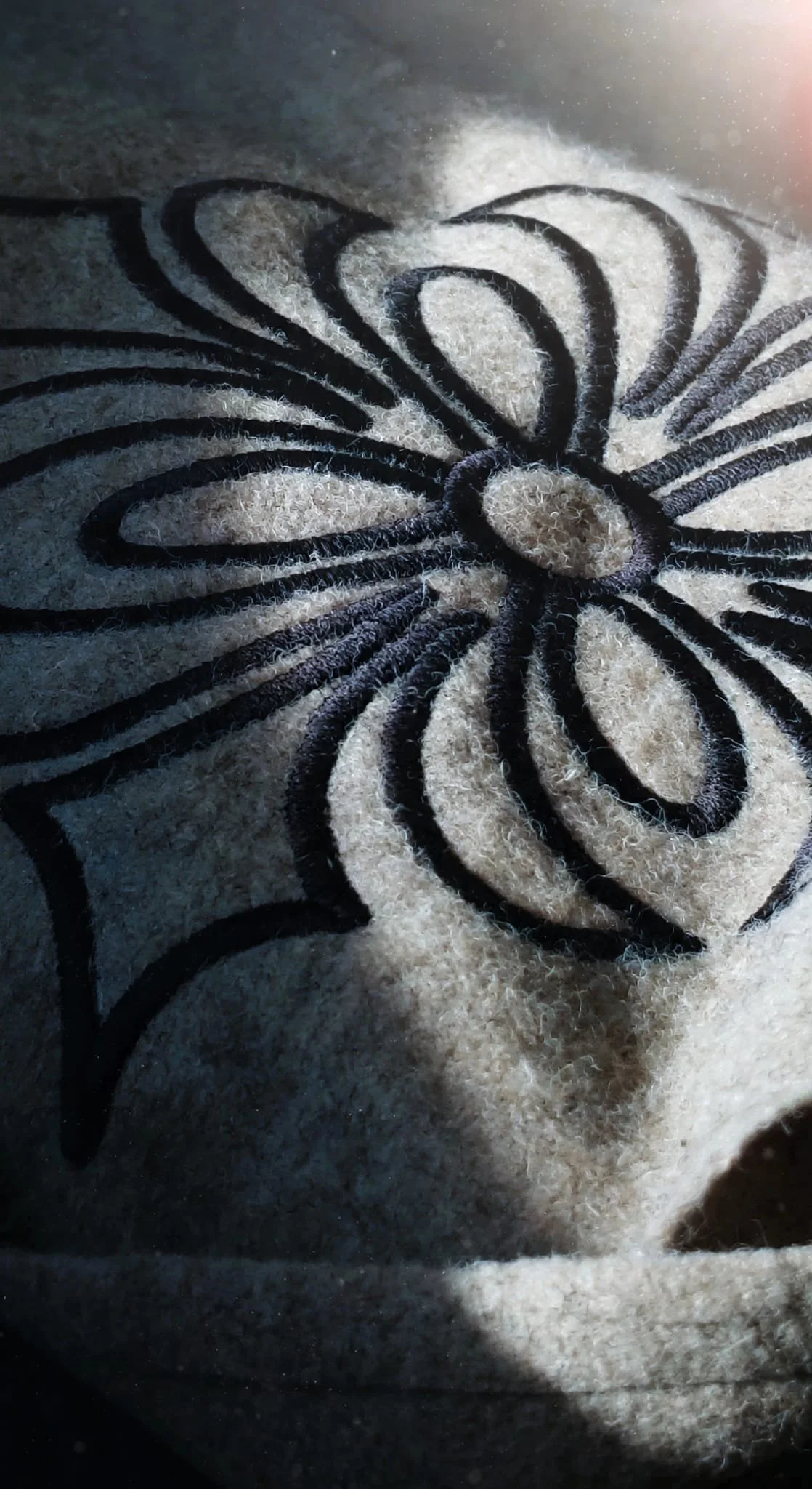 Detailed view of floral embroidery inspired by Portuguese craftsmanship.