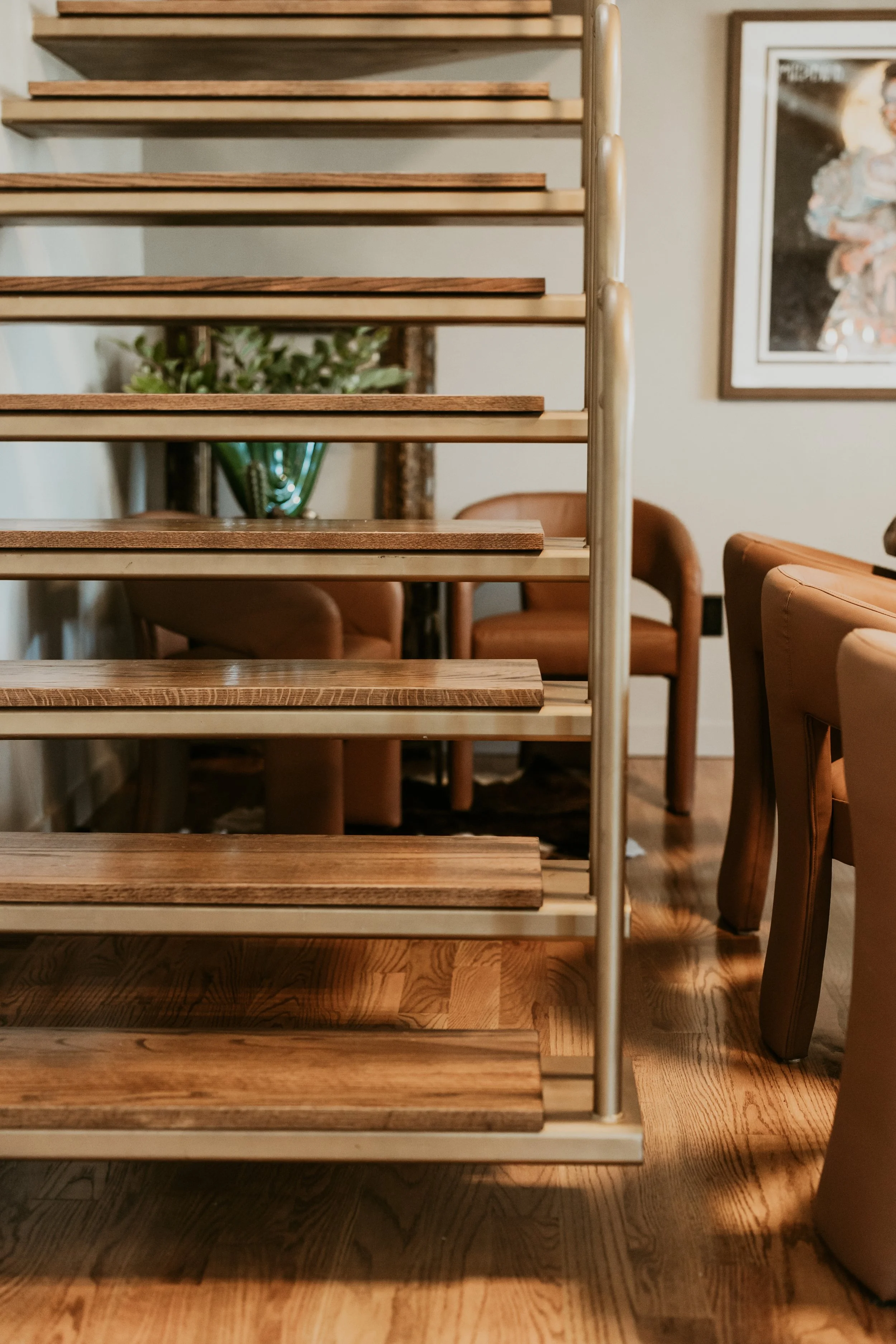 Wooden staircase with metal railing in a cozy interior space.