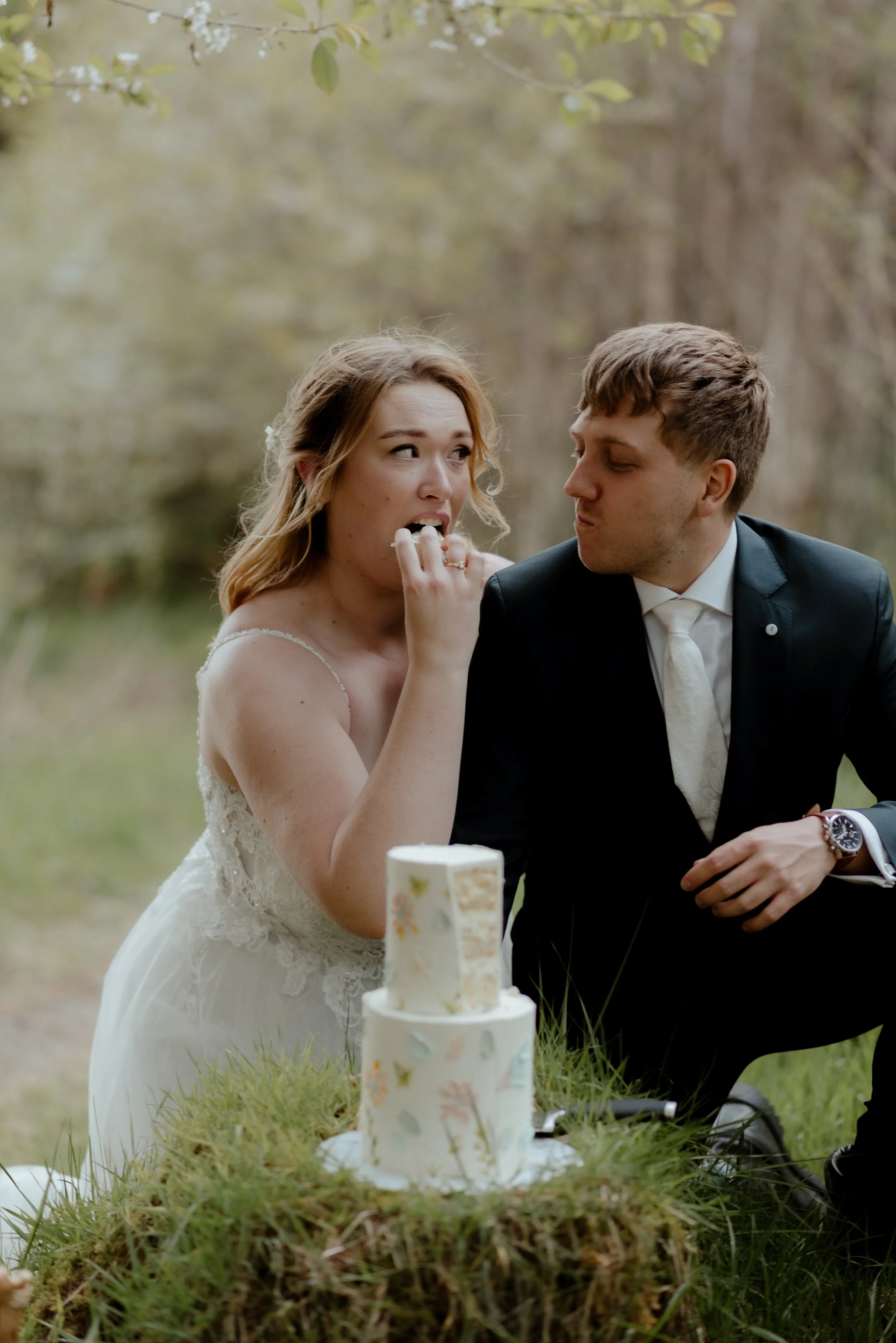 Couple enjoying their wedding cake during and intimate Scottish wedding celebration.