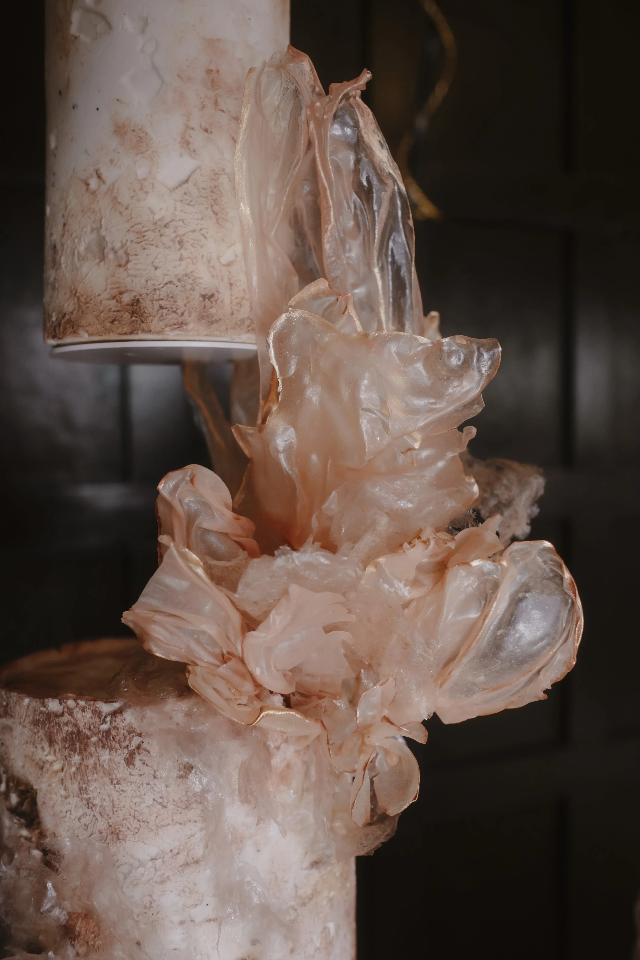 Close-up of sculptural handcrafted rice paper details on a contemporary luxury wedding cake with textured finishes and soft blush tones, at Achnagairn Castle.