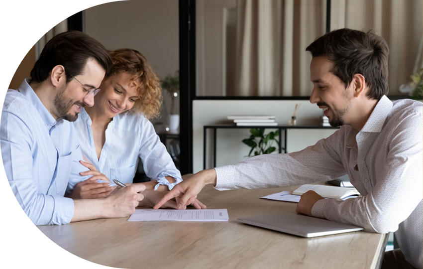 A photograph depicting a man presenting a document to a man and woman.