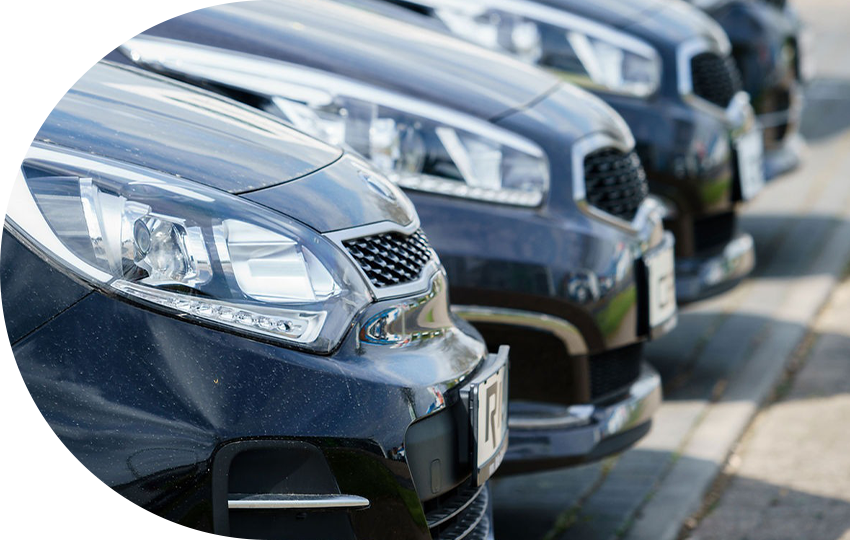 A photograph depicting a group of cars lined up in sequence.