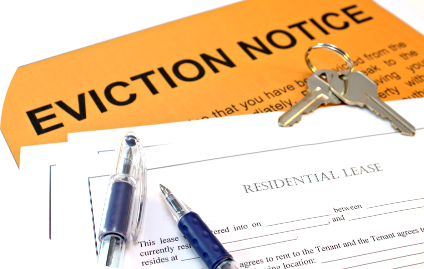 A photograph depicting a paper that says “Eviction Notice”, a pair of keys, a pair of pens, and a paper that says “Resident Lease”.