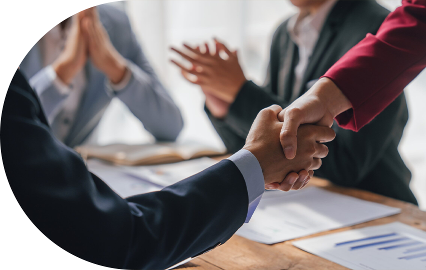 A photograph depicting two people shaking hands.