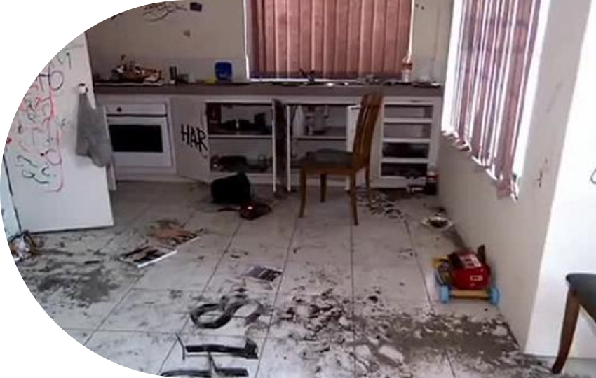 A photograph depicting a room with dirt and misplaced objects scattered across the floor.