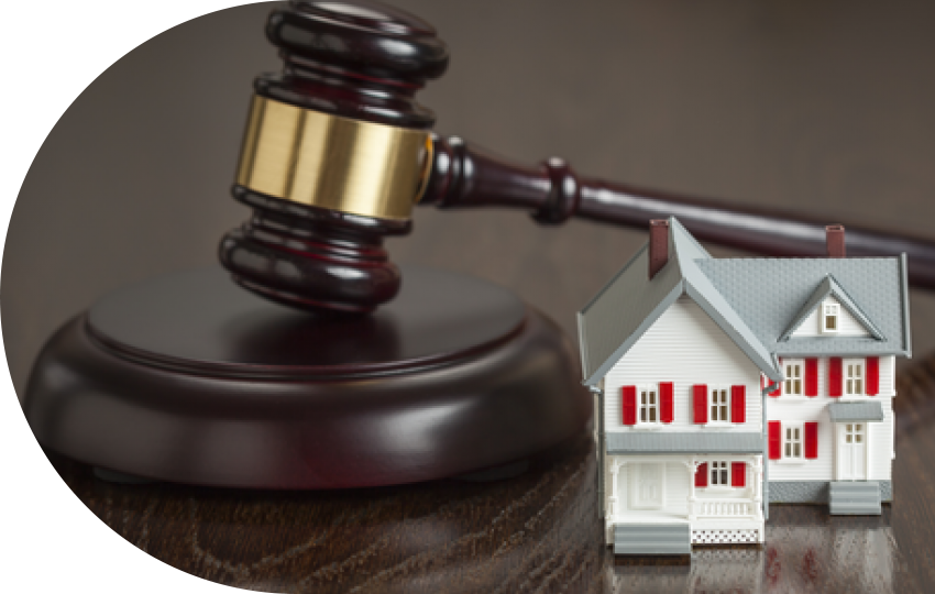 A photograph depicting a gavel and a miniature-sized house.
