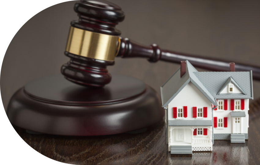 A photograph depicting a gavel and a miniature-sized house.
