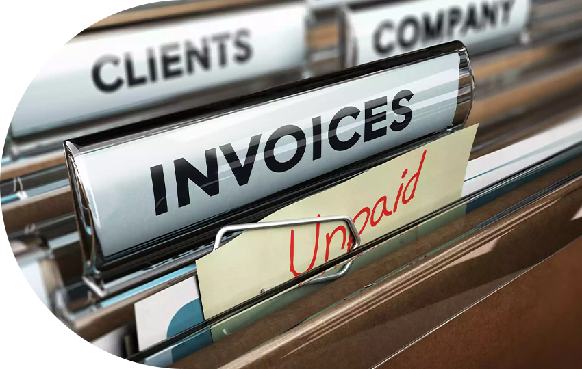 A photograph depicting a filing cabinet, focusing on a section containing unpaid invoices.