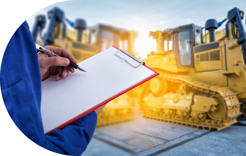 A photograph depicting a person holding a pen and clipboard while standing at a construction site.
