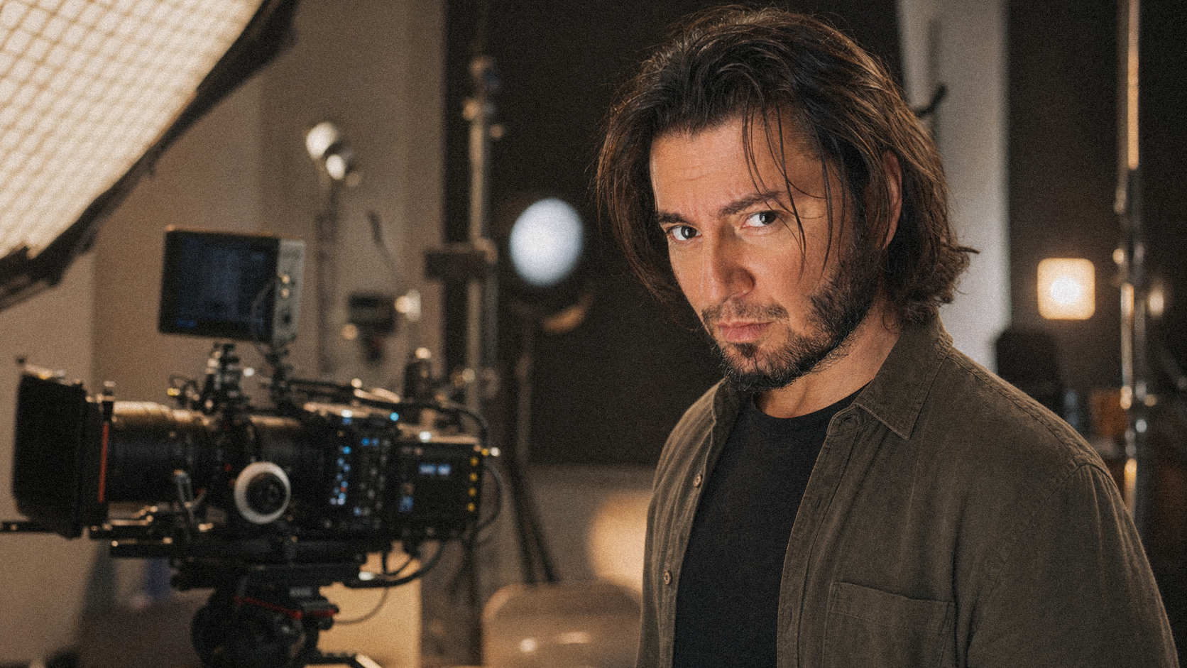Dragos Enache, photographer and filmmaker, standing beside a cinema camera during a studio production.