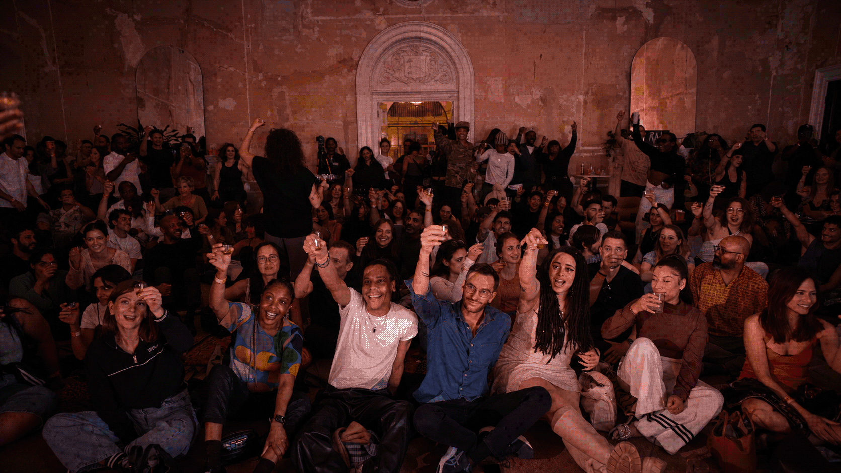 Audience at RAW uncensored storytelling raise a toast at the 4 year RAW anniversary