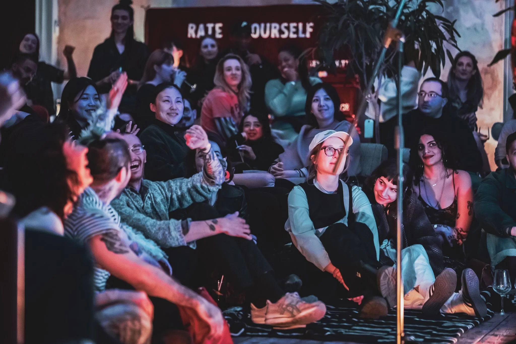 Audience at a RAW uncensored storytelling night, some smiling and laughing