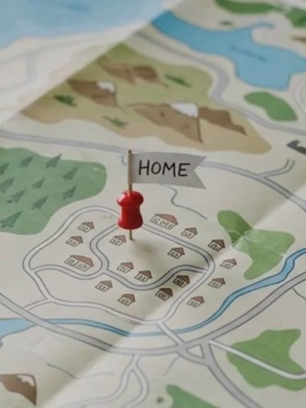 A map with a red pushpin and a small white flag labeled 'HOME' located near a cluster of houses.