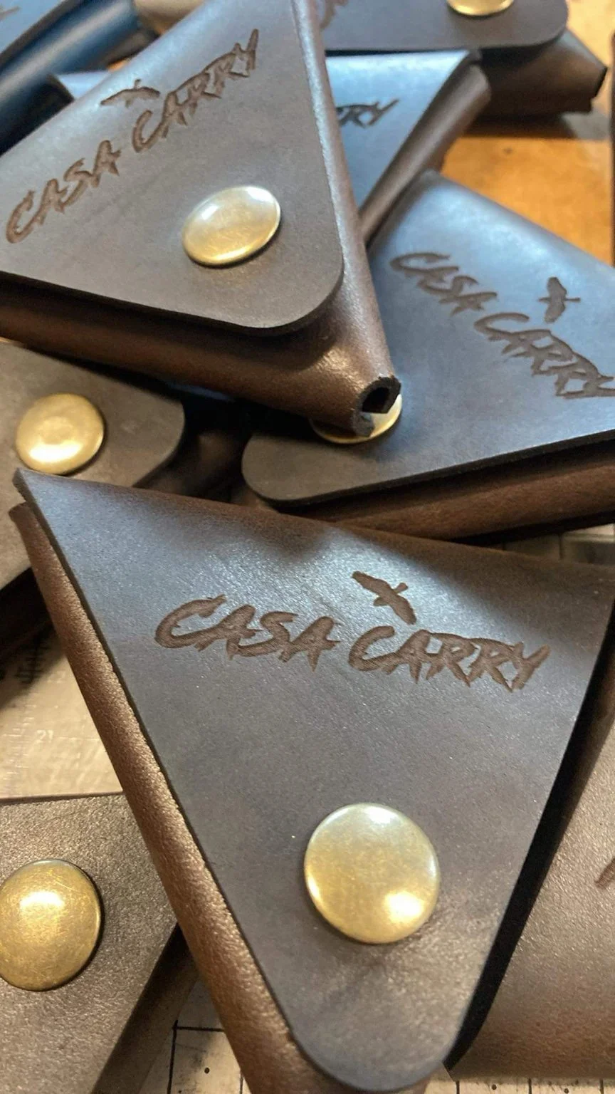 Casa Carry — triangular leather coin pouches with brass snaps