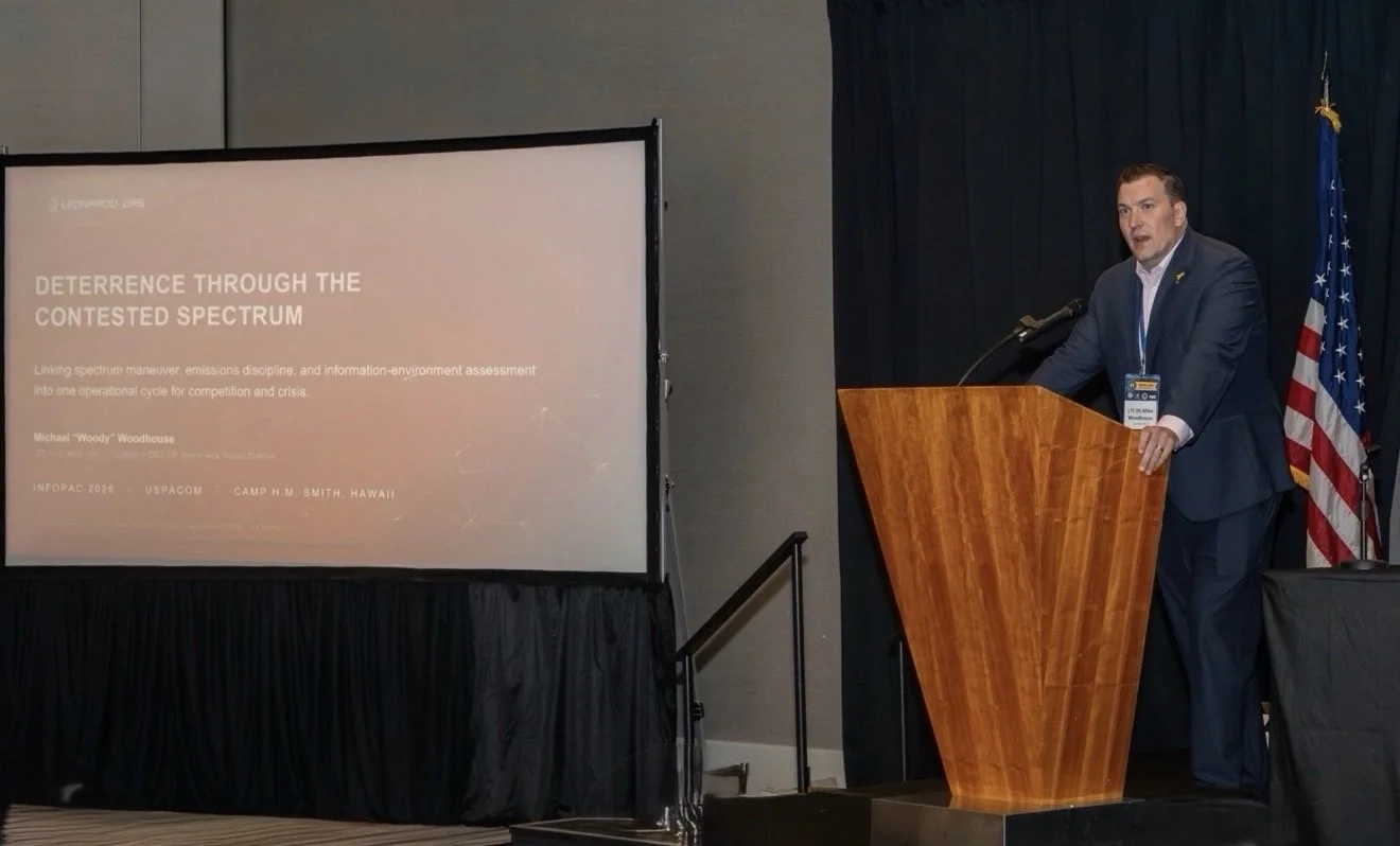 Mike "Woody" Woodhouse speaking at a podium
