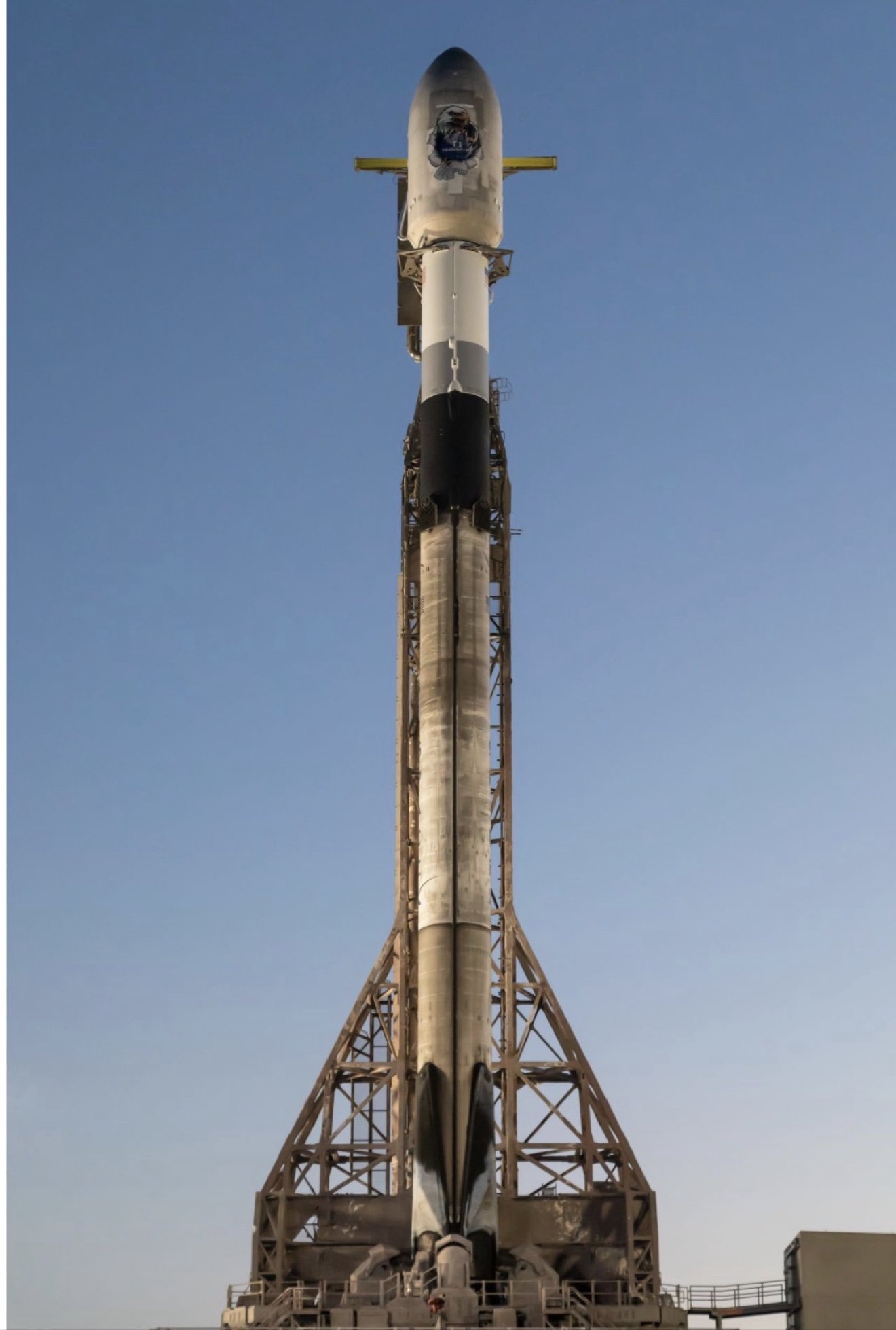 Woody's SDA Tranche 1 Transport Layer mission art on a SpaceX Falcon 9 fairing — on the pad