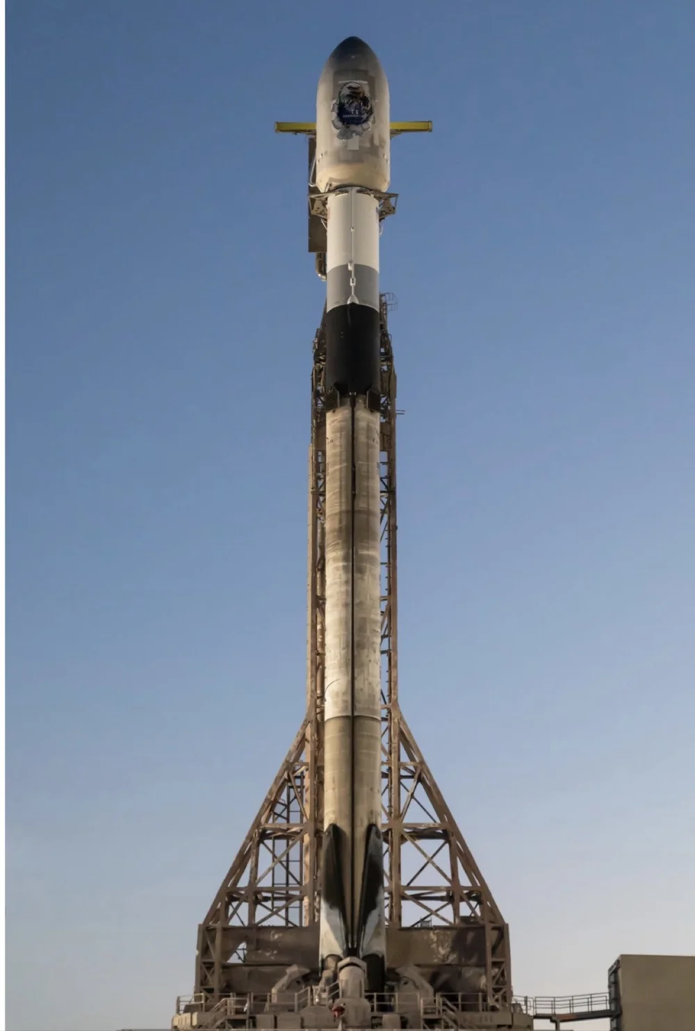 SpaceX Falcon 9 on the launch pad with Woody’s SDA mission artwork on its fairing