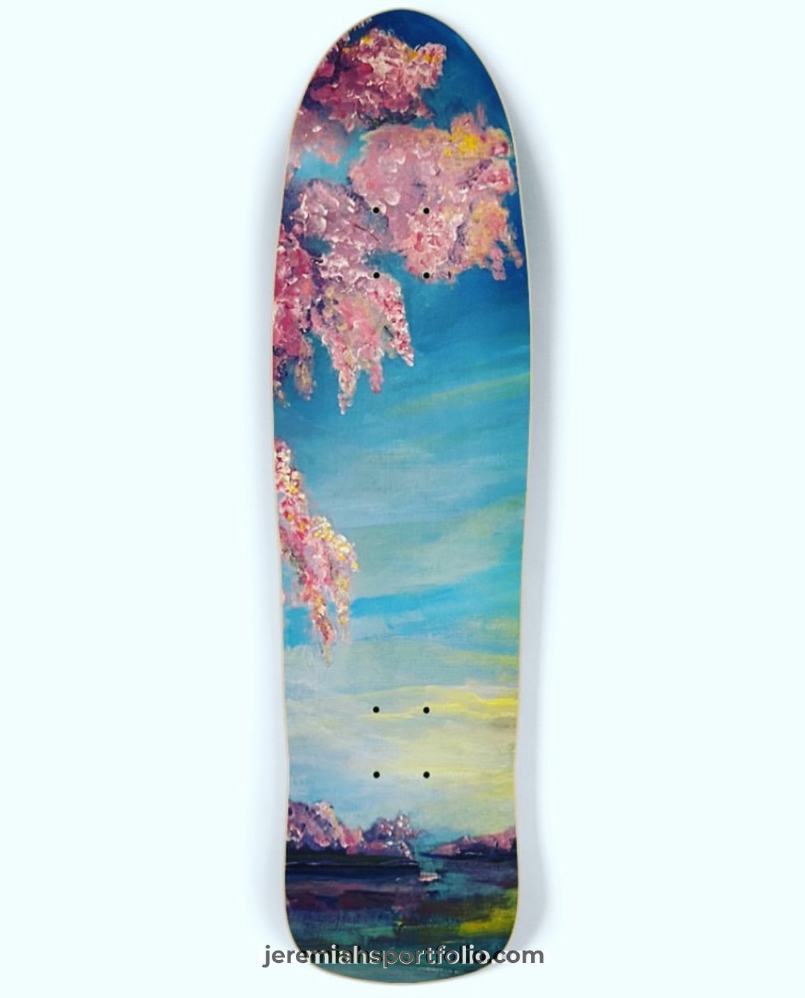 Skateboard deck with a landscape painting of pink cherry blossoms and a blue sky.
