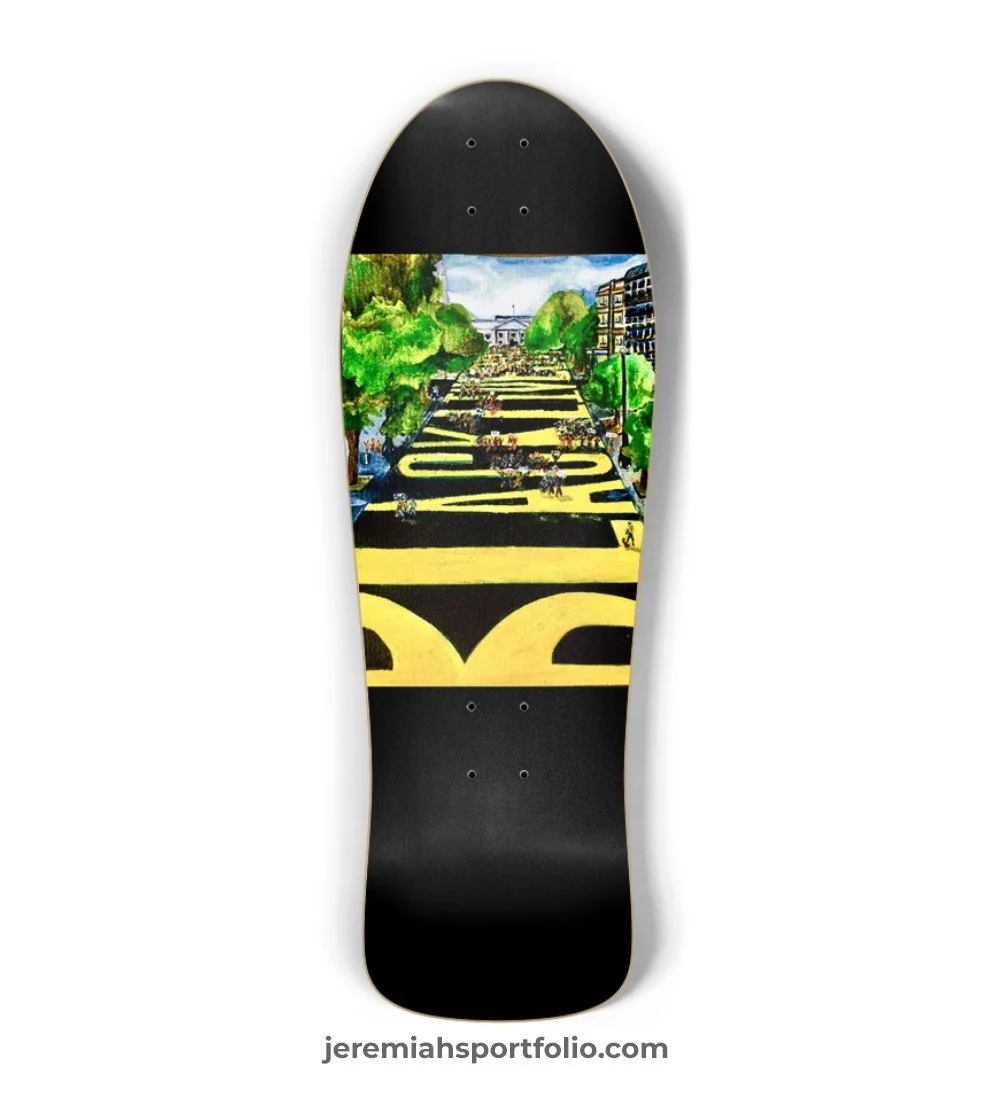Skateboard with artwork depicting a city scene with trees, buildings, and people, with the phrase "Downtown LA" written across the street.