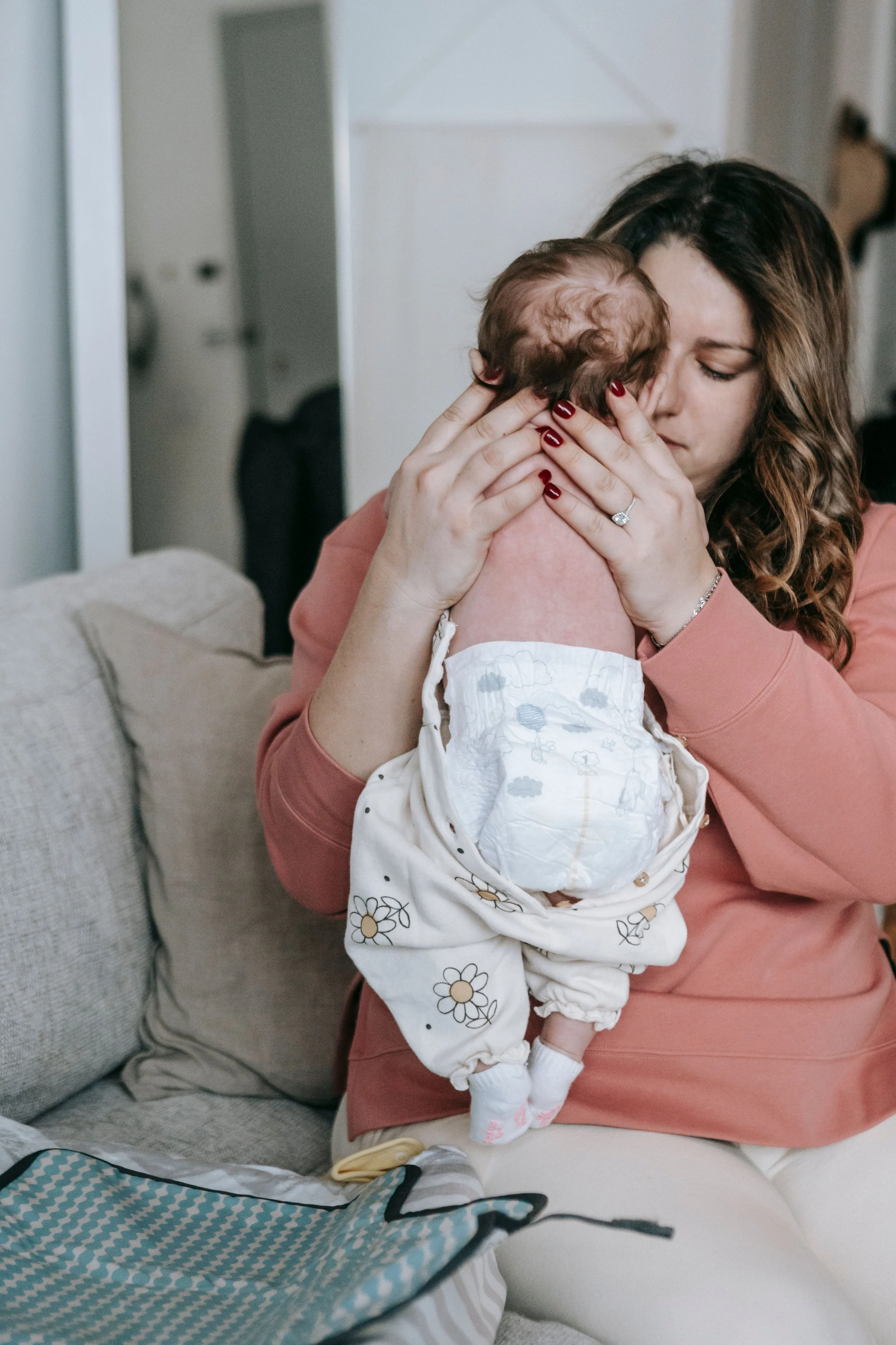 Mom picking up newborn baby