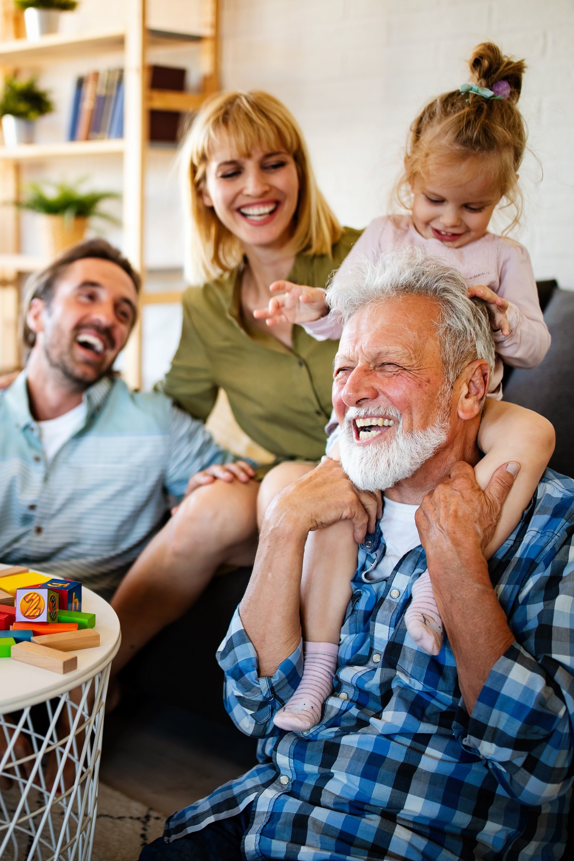 granparent and child with family playing