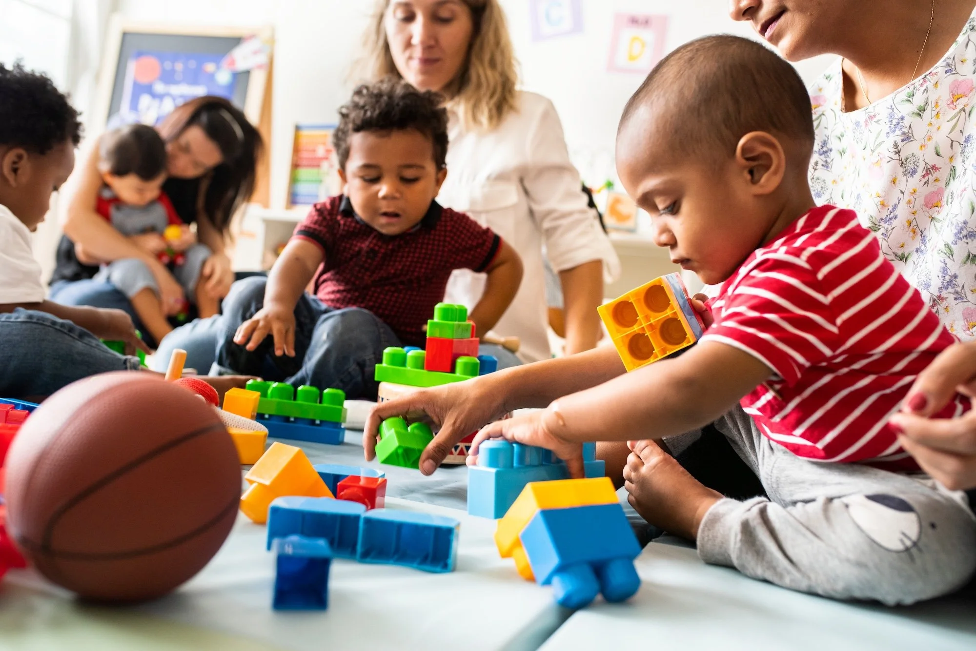 Boys playing with blocks with teachers