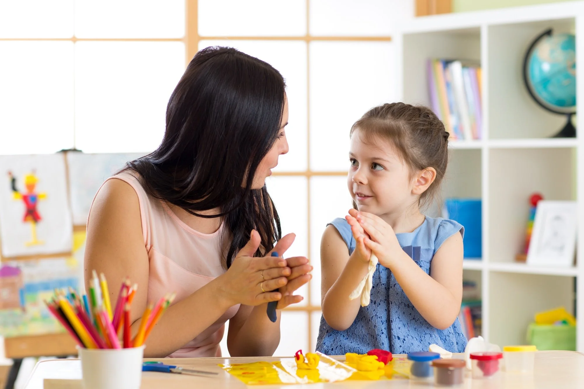 woman and young girl playing with playdough