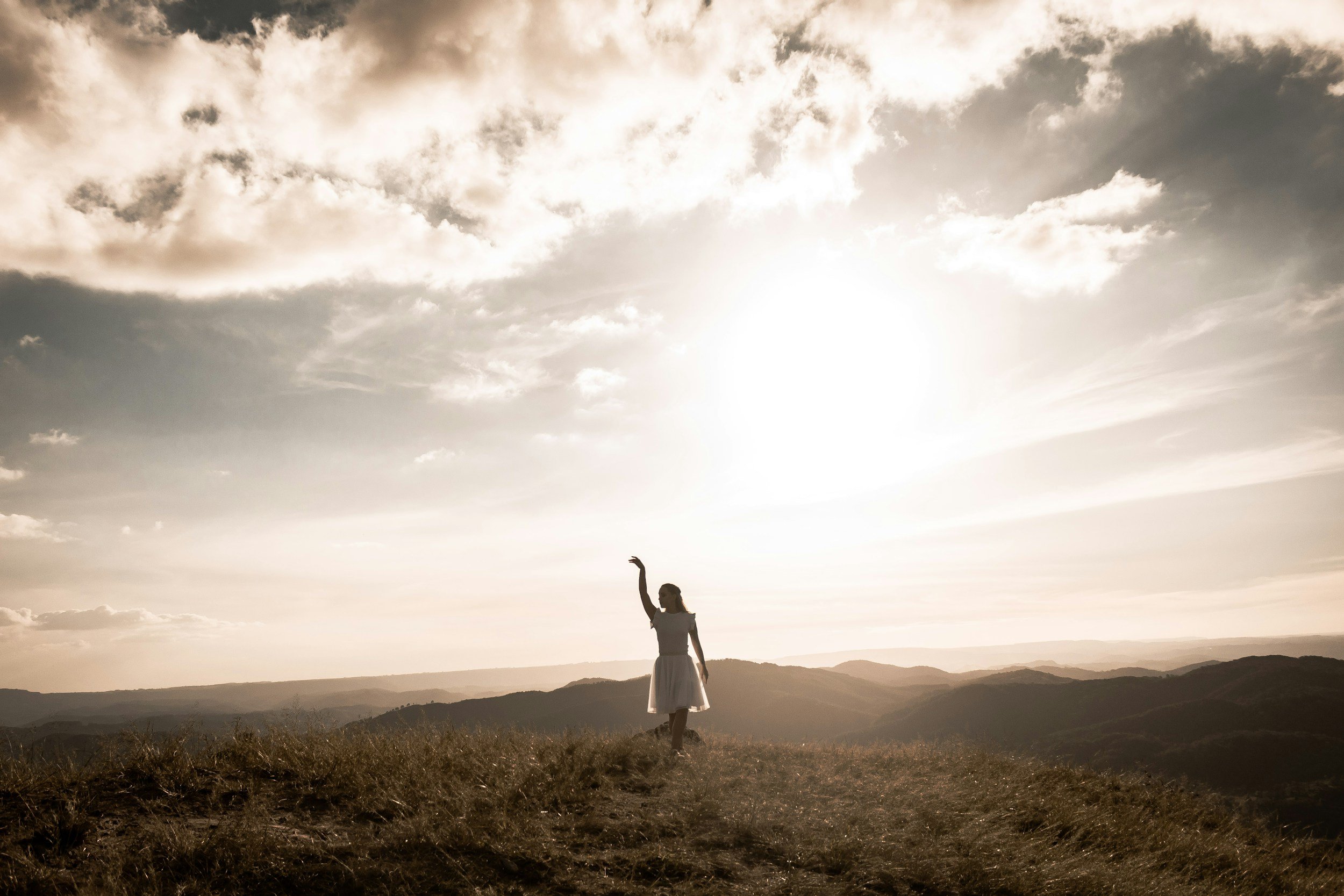 bright light sun in background women shaded with arm up
