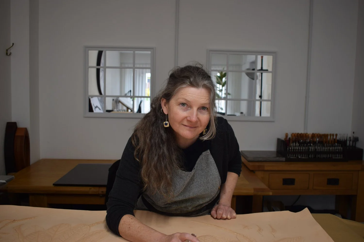Adrienne Holman carving leather in her studio.