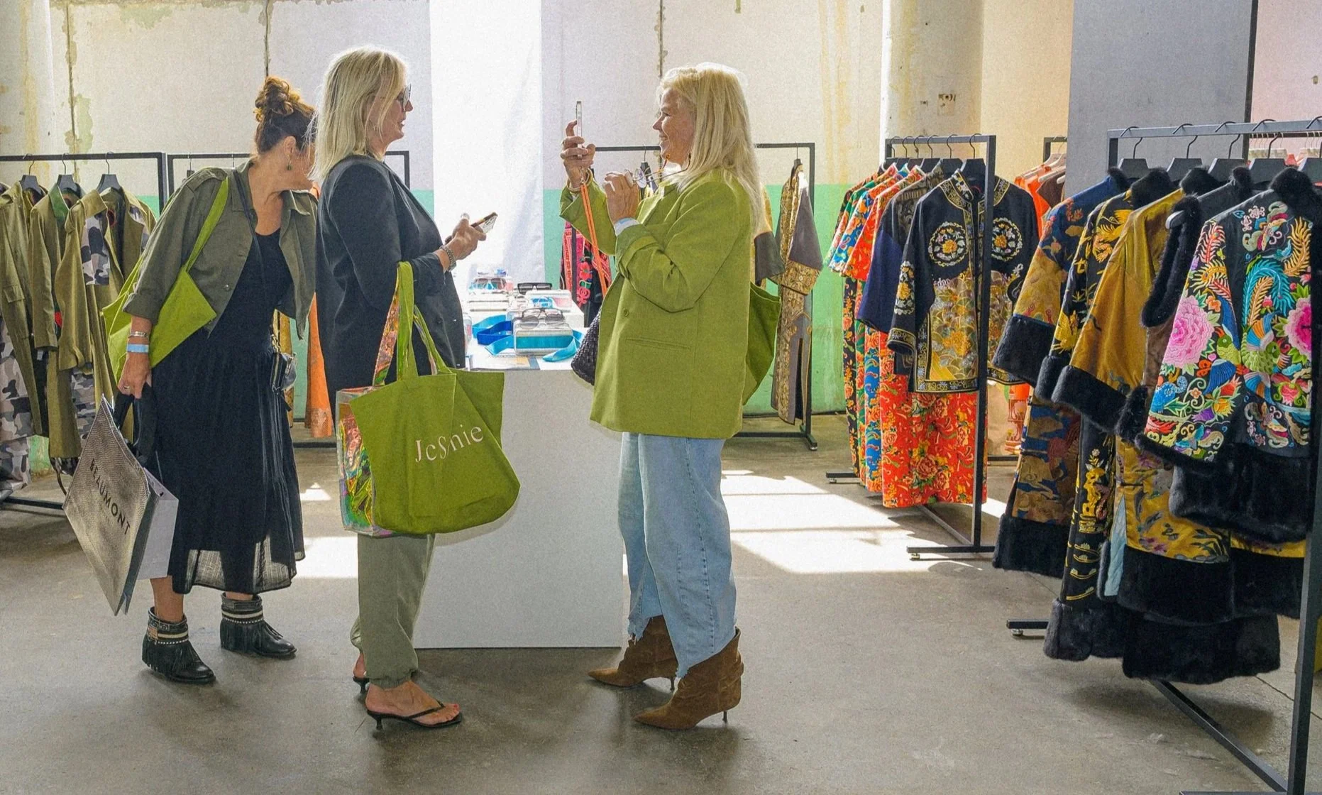 Visitors browsing the SHEGUANG HU JIN collection garments at Modefabriek