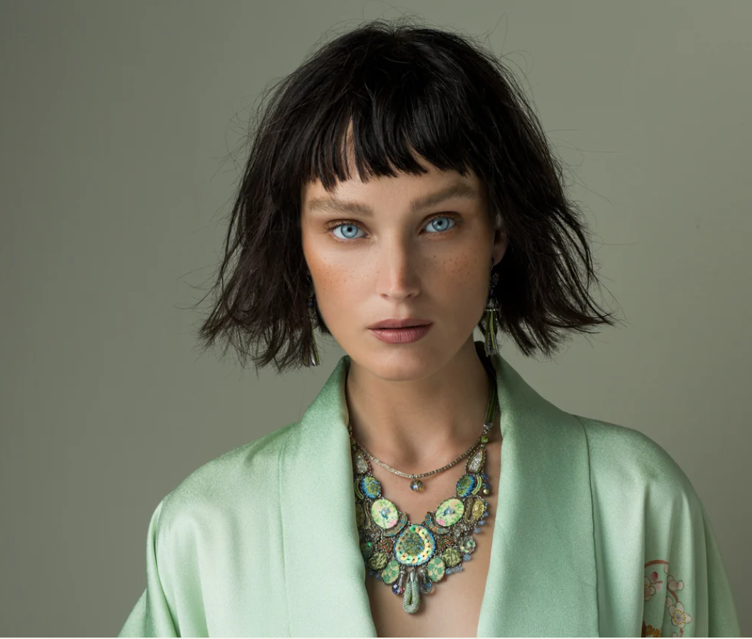 Model wearing Ayala Bar artistic jewellery and green necklace