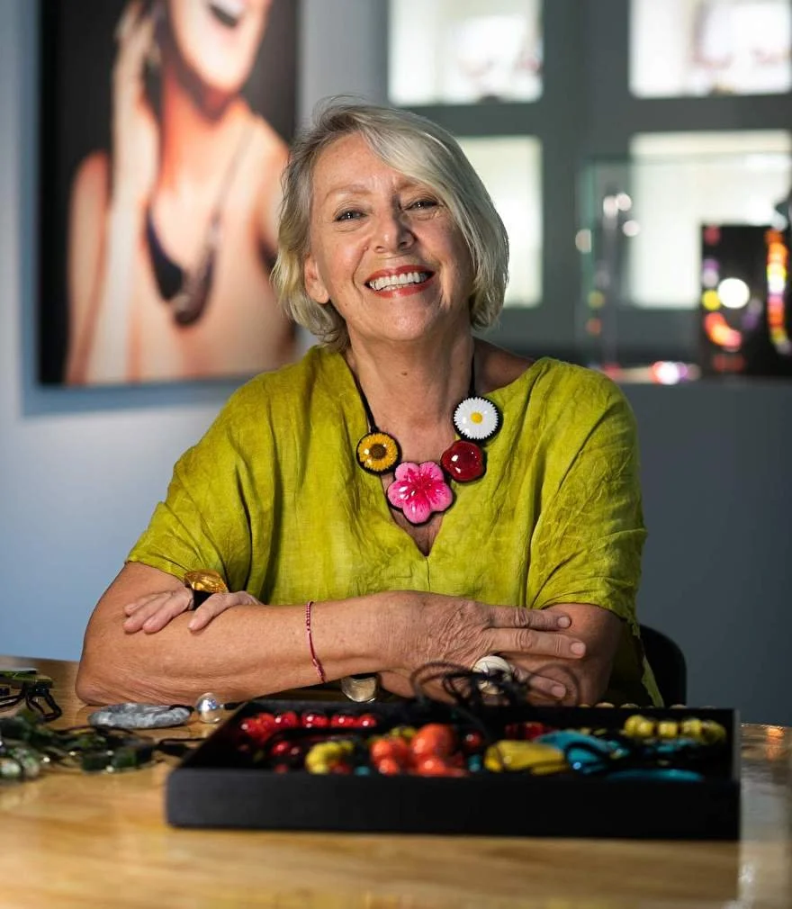 Artisan hand-painting a ZSISKA resin jewellery piece in the studio
