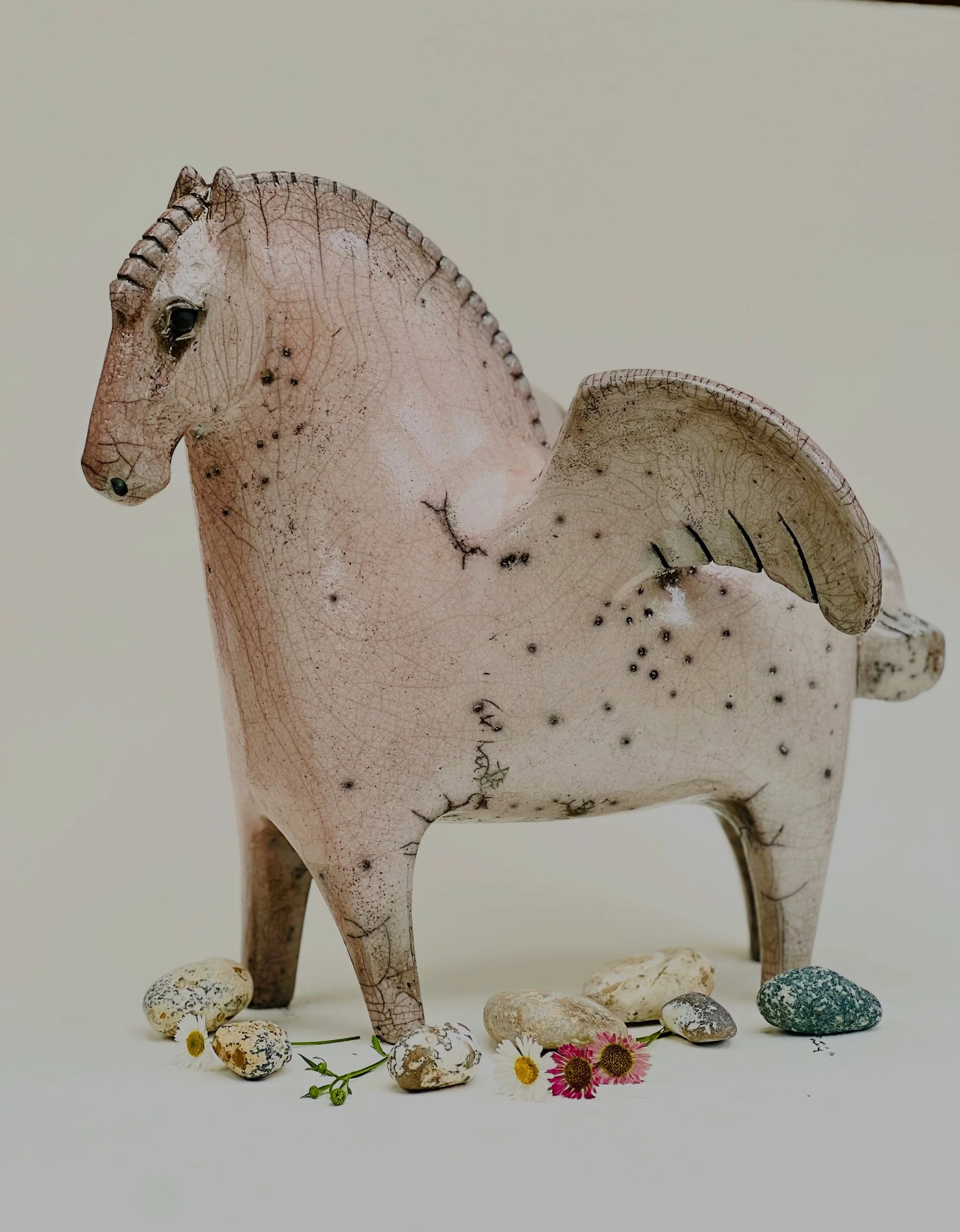 I made a pink Pegasus.
This one was a challenge to get out of the raku kiln but luckily it made it! 

Stoneware sculpture, raku fired.
#rakupottery