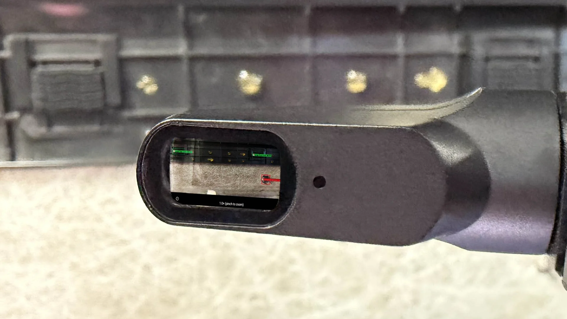 Close-up of Vuzix smart glasses streaming Detect-It Net Mobile, showing a live inspection of a headliner and results streaming back to the headset viewfinder.